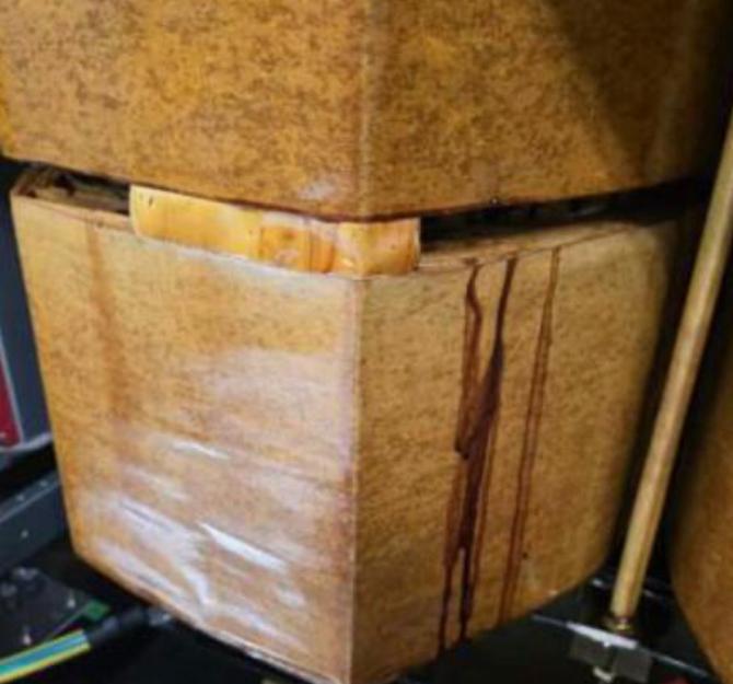 Original close-up photograph showing reported resin seepage on a transformer coil