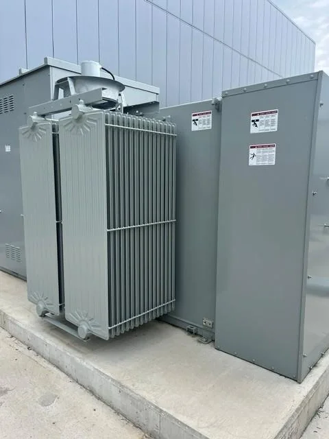 Liquid-filled transformer cooling fins and unit-substation enclosure