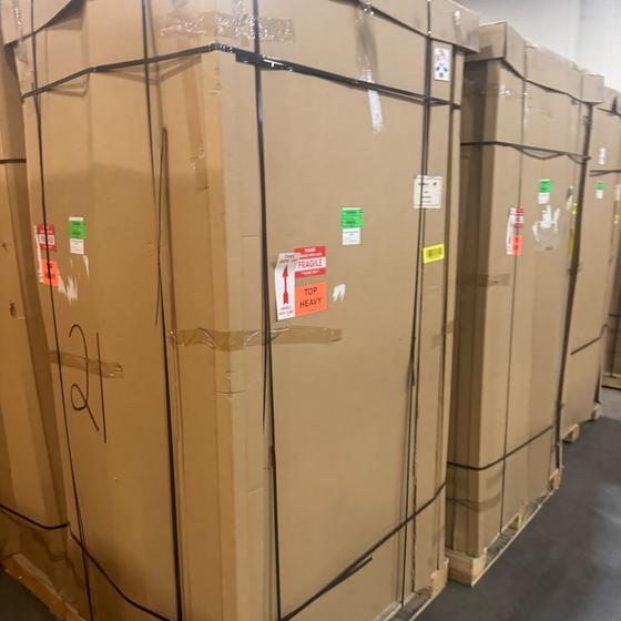 Factory crated EV charging stations palletized in warehouse