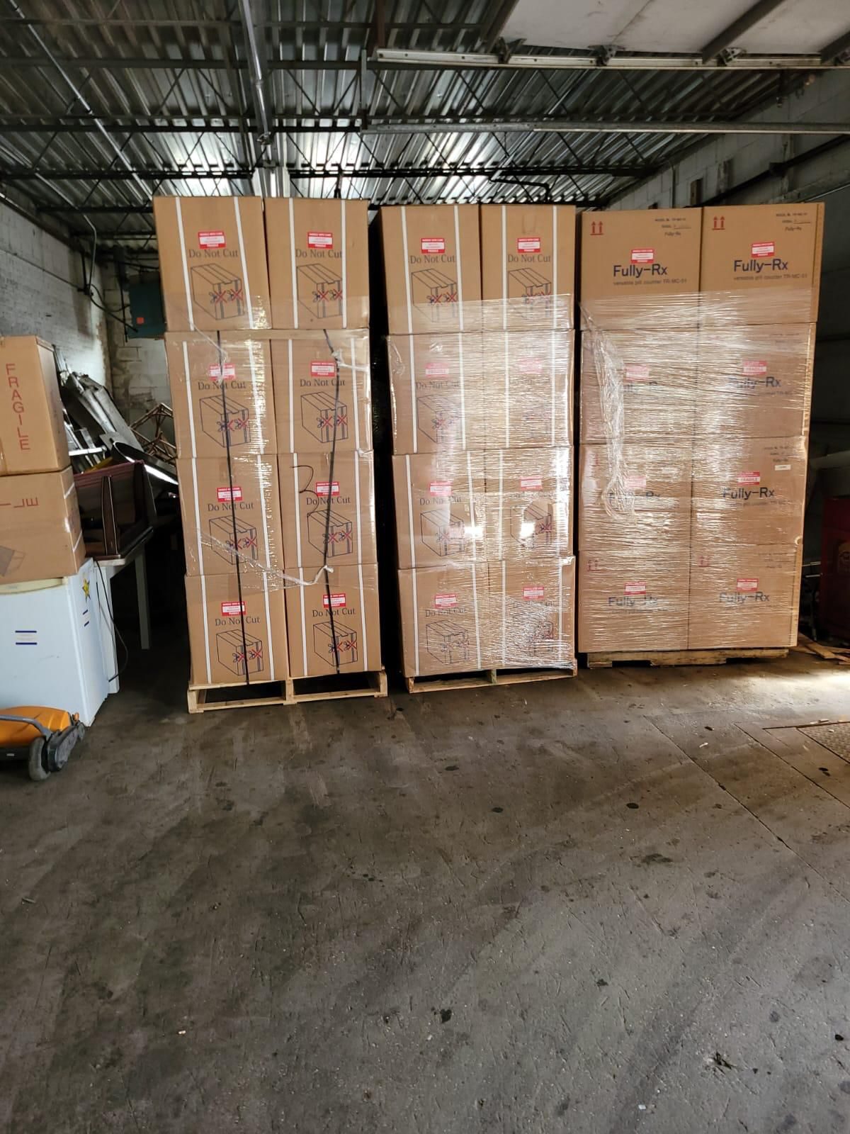 Pallets of factory sealed Yuyama Fully-Rx pill counters in warehouse